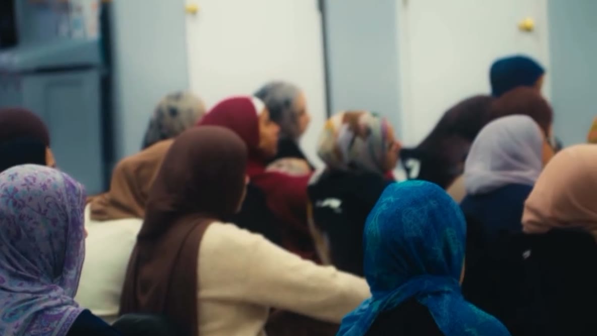 Women in hijabs, seen from behind, listening to the talk at Sifr Circles.